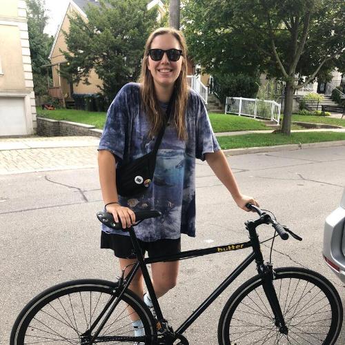 A rider standing with her new 53 single speed outside the shop